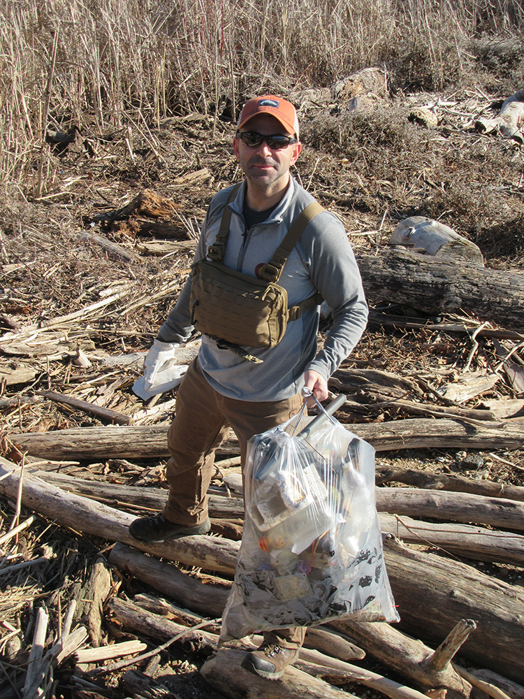 Marken Orser filled a bag with trash near the boardwalk